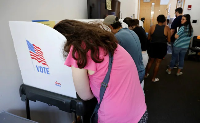 In tense political atmosphere, voters head to in-person balloting in US midterms